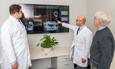 Doctor evaluating a 3D x-ray with a patient during a consultation.