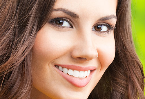 Stock image of a woman smiling after receiving Cosmetic Dentistry.