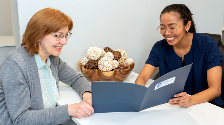 Image of a patient and financial coordinator reviewing Insurance and Financing information.